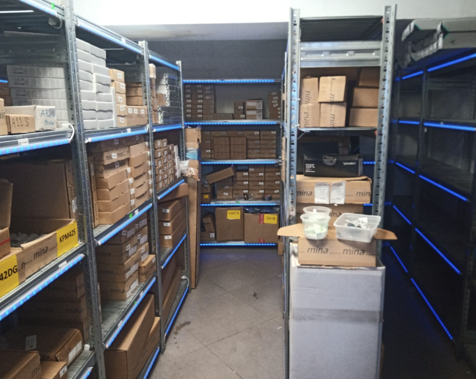 Small-parts depot with blue LED strips along the shelf-edge racking